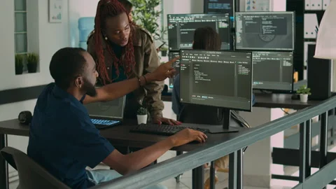 African american team of developers talking about source code running on screen Stock Footage 227615143