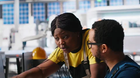 African american team programs robotic arms in solar panel facility Video stock 309070754