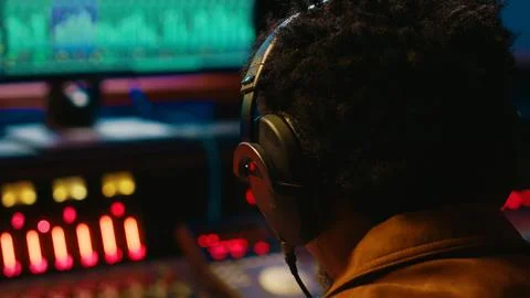 African american tracking engineer processing and mixing sounds in control room Stock Photos
