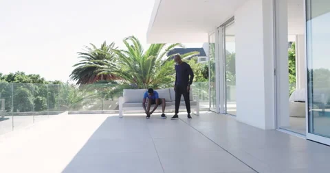 African American trainer and trainee in athletic wear stretching after tying Stock Footage 313229747