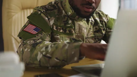African American U.S. serviceman types on laptop, planning defense operations Stock Footage 342149416