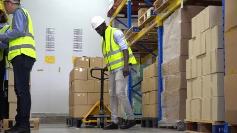 African american warehouse worker  pulling a pallet truck Stock Footage 144110908