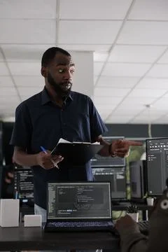 African american web developer analyzing html script on terminal window Stock Photos