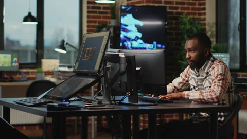 African american web developer working in artistic office to create CGI content Video stock 223428445