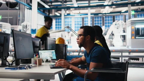 African american wheelchair user testing CAD software for manufacturing Stock Footage 309076497