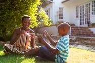 African American Woman And Her Son, Spending Time Together In The Garden Stock Photos