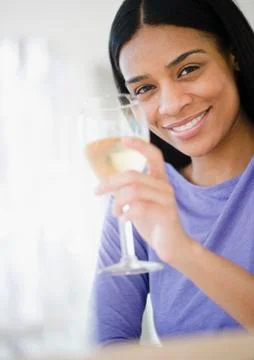 African american woman drinking white wine Stock Photos