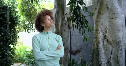African American woman in mint pullover looking up as camera moving, relaxing, Stock Footage 338326016