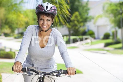 African american woman riding bike Stock Photos