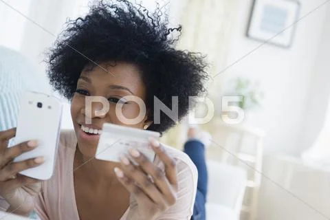 African American Woman Shopping On Cell Phone