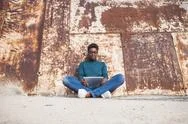 African American Woman Sitting On Ground Using Digital Tablet Stock Photos