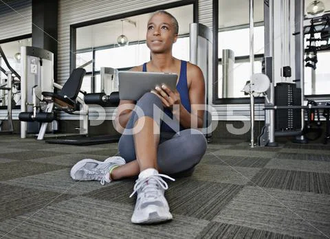 African American Woman Using Digital Tablet In Health Club