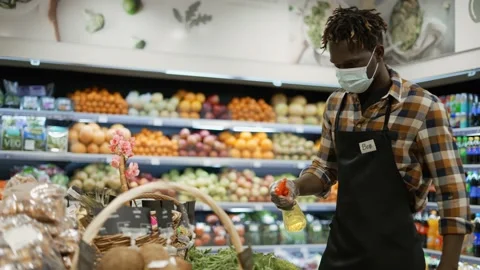 African american worker refreshing and arranging greens in the store Stock Footage 151672247