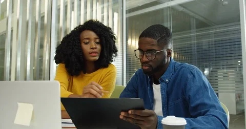 African american young couple of the office co-workers sitting at the computer Stock Footage