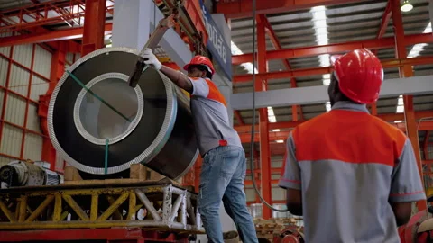 African Americans worker are using hoists and cranes to lift steel or goods Stock Footage 175778279