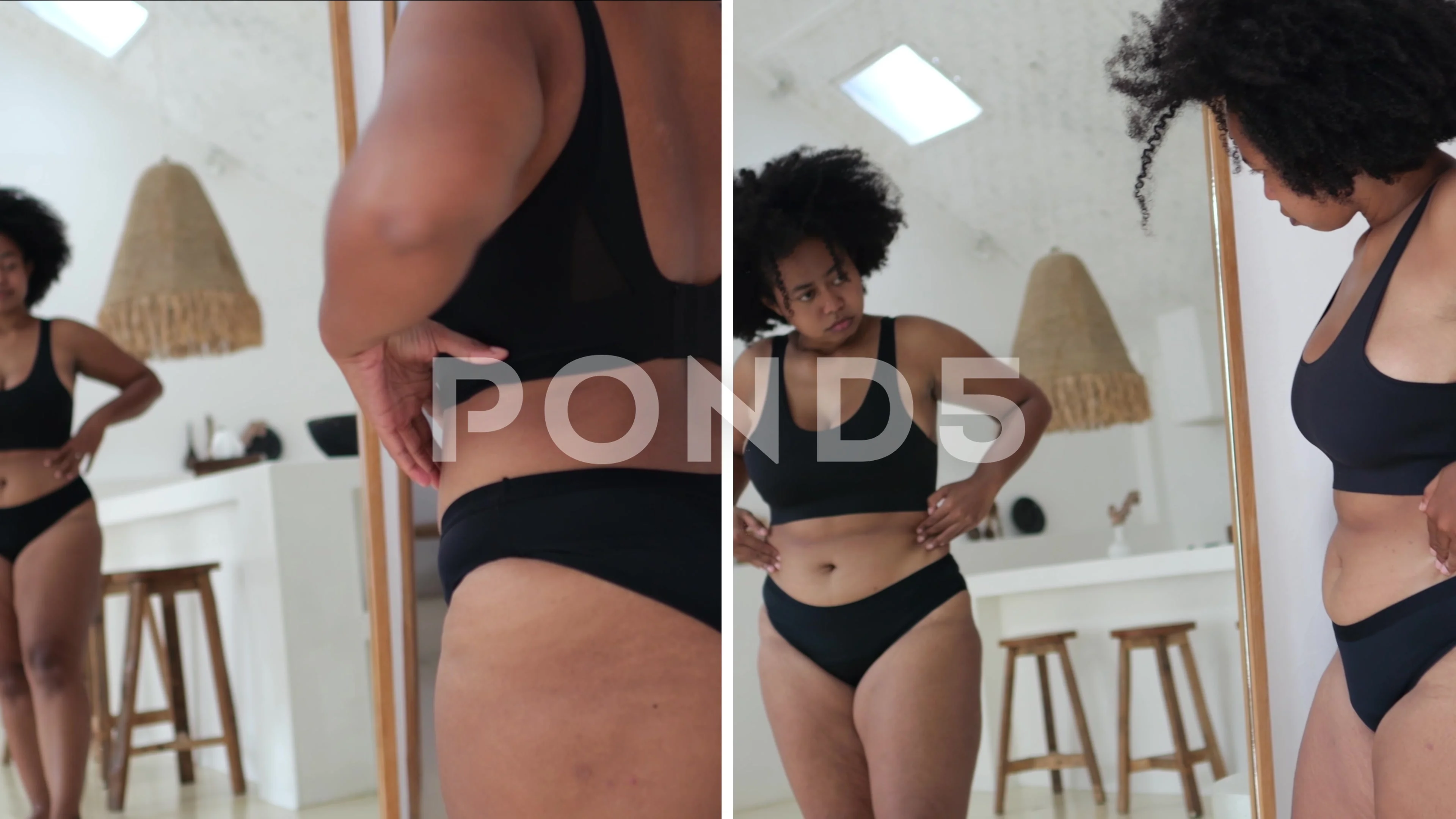 African Asian woman in black lingerie examines her cellulite in front of a