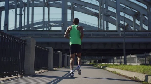 African athlete running on bridge Stock Footage 117061784