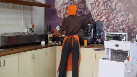 African barista making coffee inside the counter in slow motion Видео 116749645