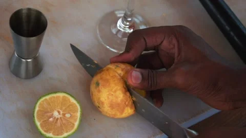 African bartender cutting passion fruit and making mojito cocktail, slow motion Stock Footage 230080390