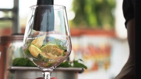 African bartender pressing lime in glass, mixing it with mint leaves. slowmo Stock Footage 230080319