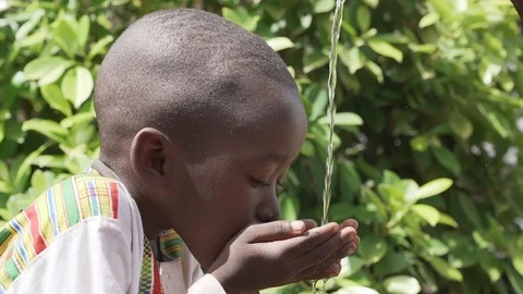 African Black Child Drinks Stock Footage 98633700