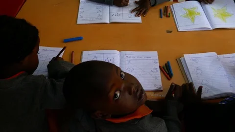 African black kid stares into the camera during art class in school. Stock Footage 91935367