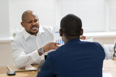 African Boss Shouting At Workplace. Conflict And Stress Stock Photos