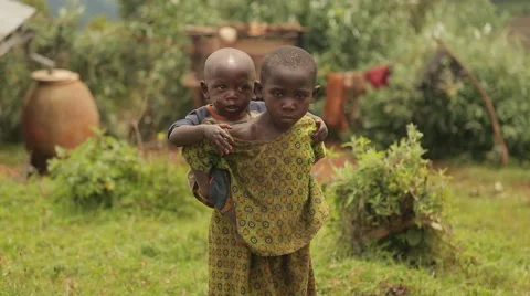 African Boy from Batwa Tribe Taking Care of His Little Brother, Uganda Stock Footage 40912447