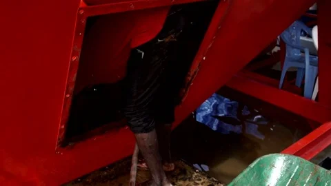 An African boy cleaning the inside of a tank with a pump. Stock Footage 69833749