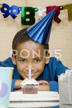 African Boy With Cupcake At Birthday Party