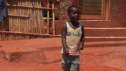 African boy drags plastic bottle along the ground in Mozambique, HD Stock Footage 118775259