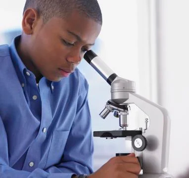 African boy looking into microscope Stock Photos