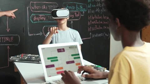 African boy programming system while caucasian girl enter metaverse. Edification Stock Footage 277157344