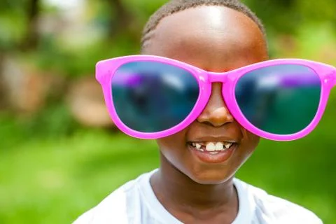 African boy wearing fun extra large sun glasses. Stock Photos