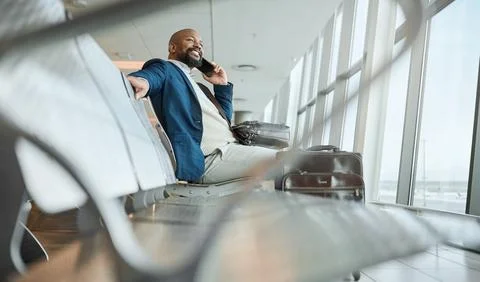 African businessman, airport and phone call with excited smile, focus and Stock Photos