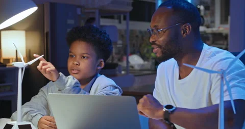 African businessman and father using computer explain about science to son. Stock Footage 244104053