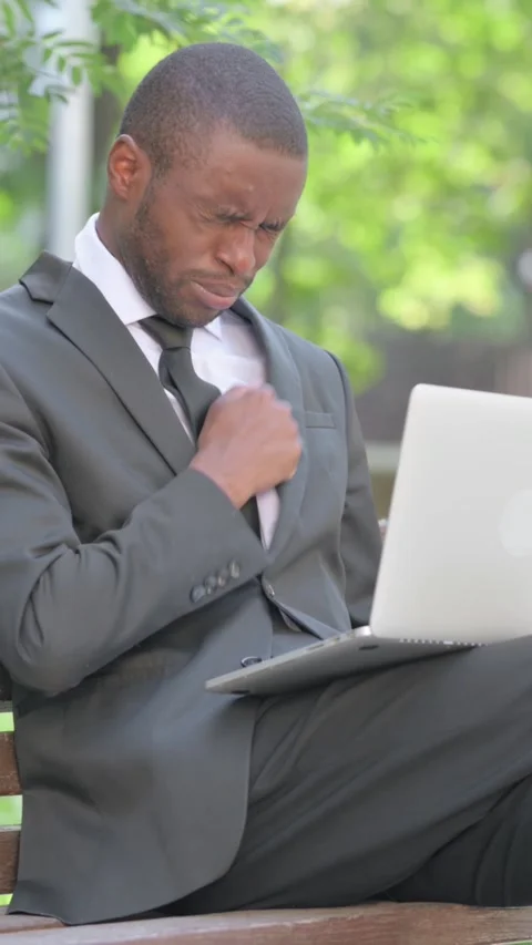 African Businessman Coughing while Using Laptop Outdoor, Vertical Video Stock Footage 319038143