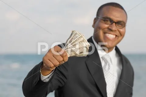 African businessman holding money Stock-Fotos