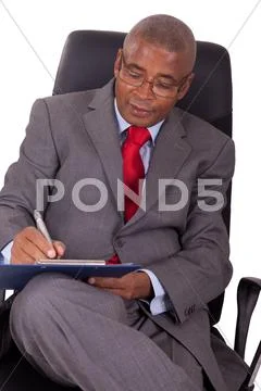 African businessman sitting in office chair isolated on white Stock Photos