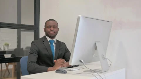 African Businessman Smiling at Camera while Working on Desktop Computer Video stock 301292433