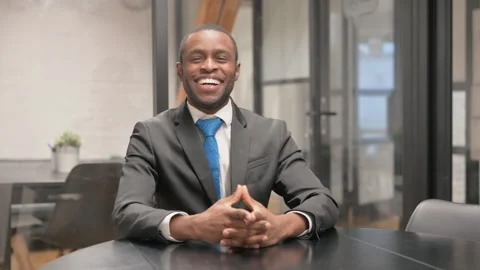 African Businessman Smiling at Camera at Work Stock Footage 302867858