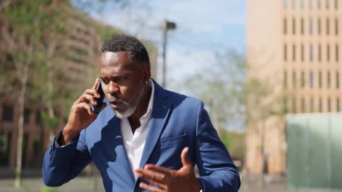 African businessman start to run while talking to the phone Stock Footage 260118325