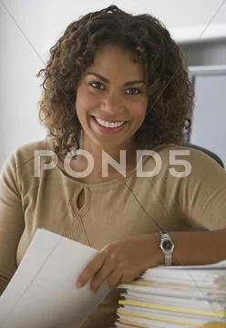 African Businesswoman Holding Paperwork
