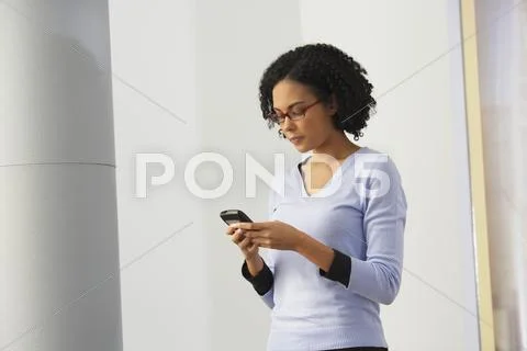 African Businesswoman Looking At Cell Phone