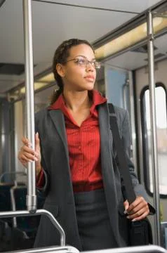 African businesswoman riding on train Stock Photos