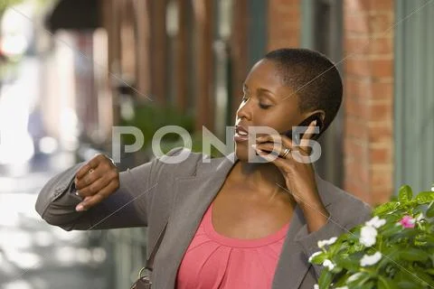 African Businesswoman Talking On Cell Phone Outdoors