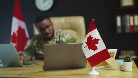 African Canadian intelligence officer plans mission, typing report on laptop Stock Footage 342149072