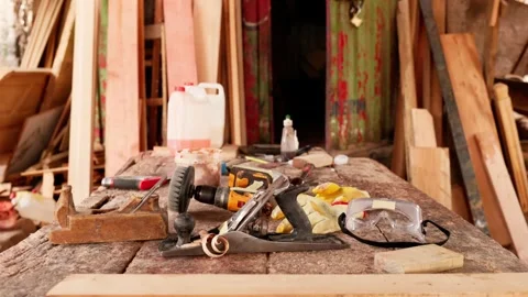 African carpenter's workshop with a rustic workbench and traditional tools Stock Footage 346734023