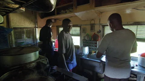 African chef cooking in the kitchen on the train, Tanzania Stock Footage 131988374