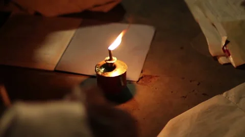 African child doing homework infront of kerosene lamp Stock Footage 57947017